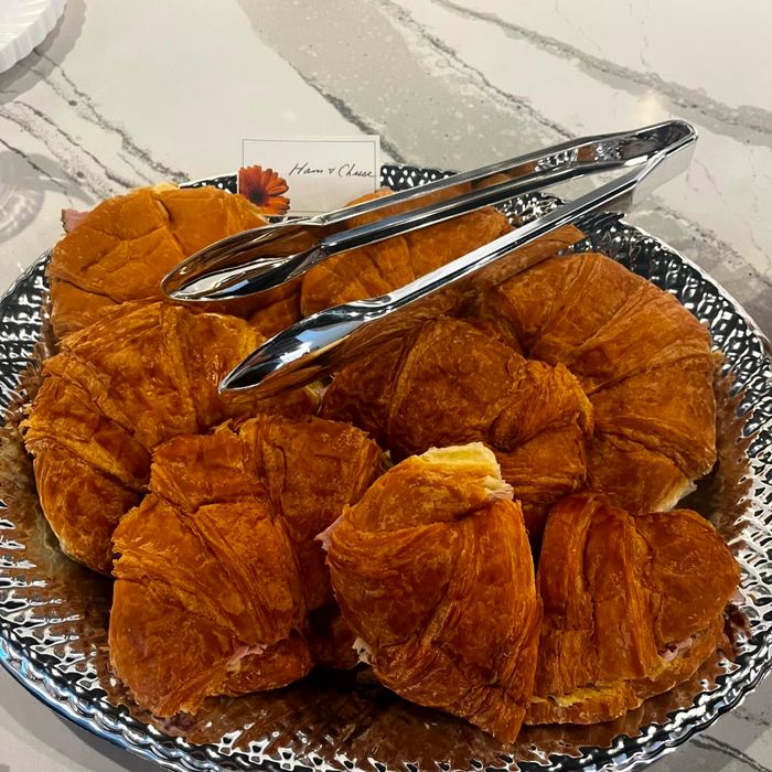Fresh croissants arranged on a silver serving tray