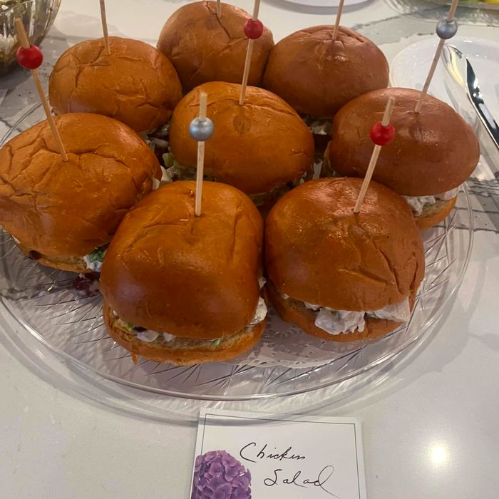 Brioche sliders on a glass stand with a handwritten place card